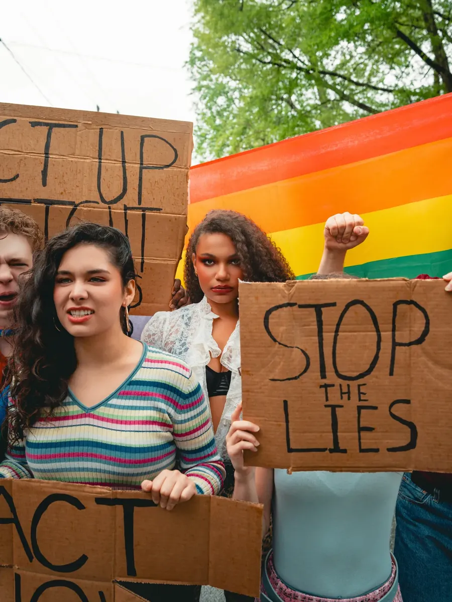 The company raises hand-painted “Stop the Lies” protest signs outside the town hall.
